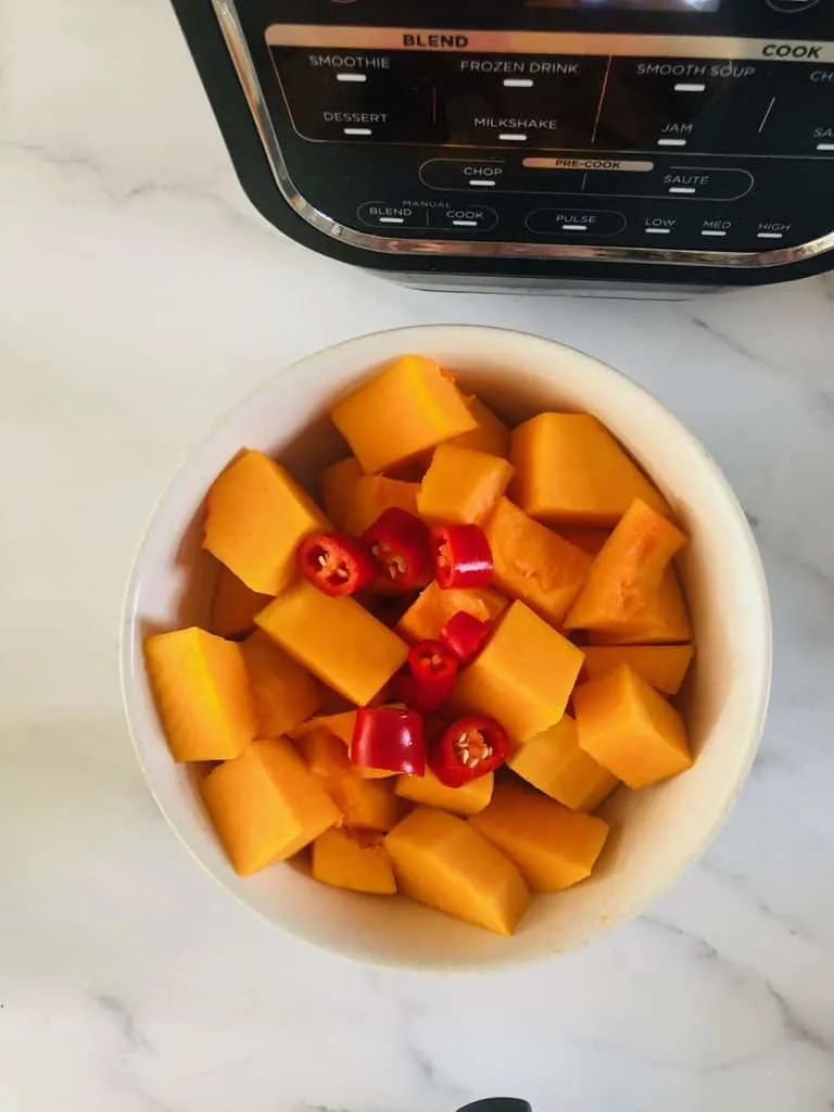 chopped butternut squash and red chilli next to Ninja Soup Maker