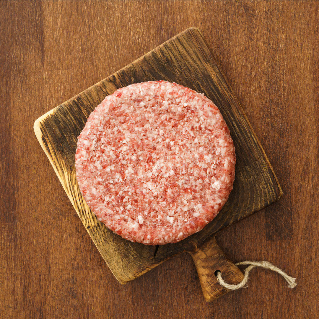 Picture of a home made burger on a chopping board