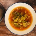 cabbage soup in bowl next to soup maker