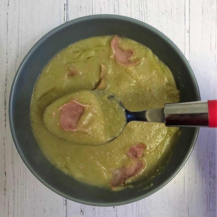 ham and pea soup in a bowl with a spoon