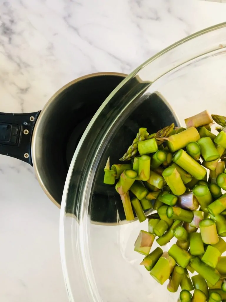 putting chopped asparagus into soup maker