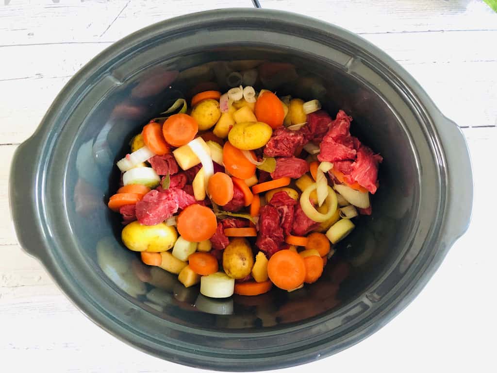 beef stew ingredients in slow cooker pot