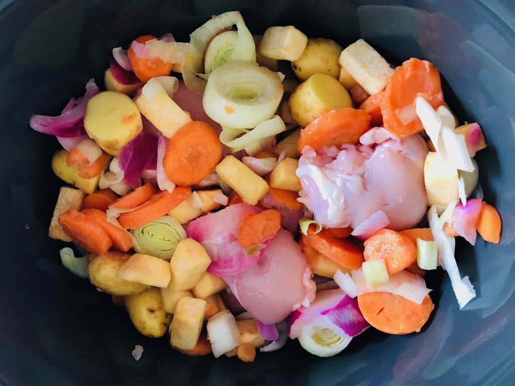 mixed vegetables and chicken in slow cooker before cooking