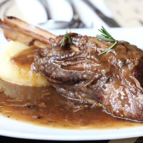 slow cooked lamb shanks with mashed potato on plate