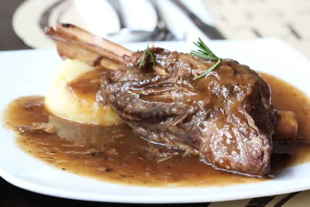 slow cooked lamb shanks with mashed potato on plate