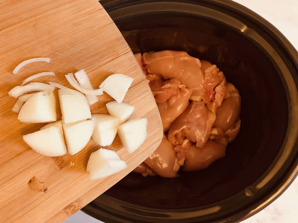 adding onions and garlic to slow cooker