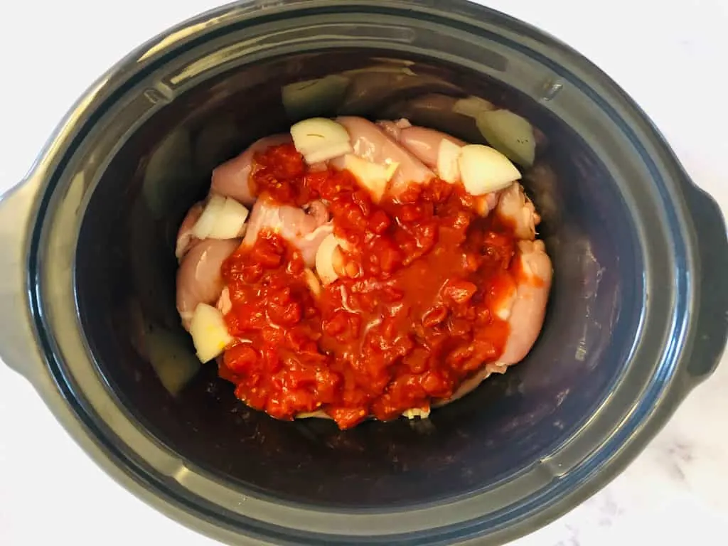 adding tomatoes to slow cooker for curry
