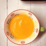 carrot and lentil soup in a bowl next to Ninja soup maker