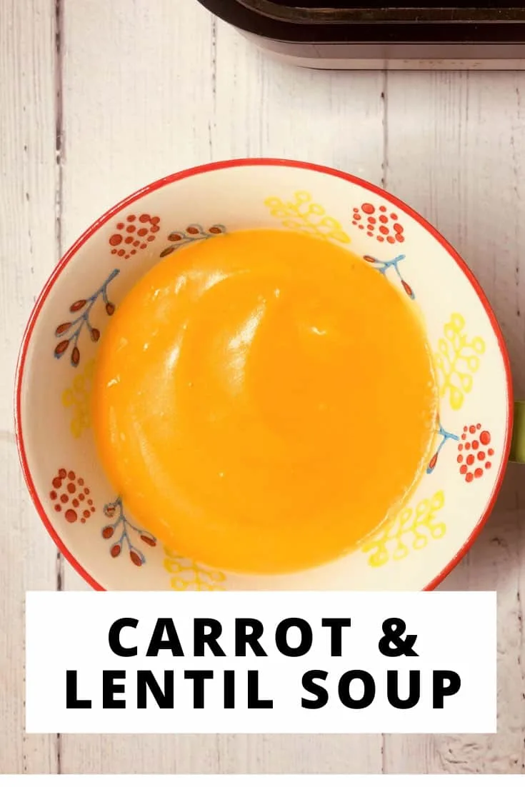 carrot and lentil soup in a bowl next to a Ninja soup maker