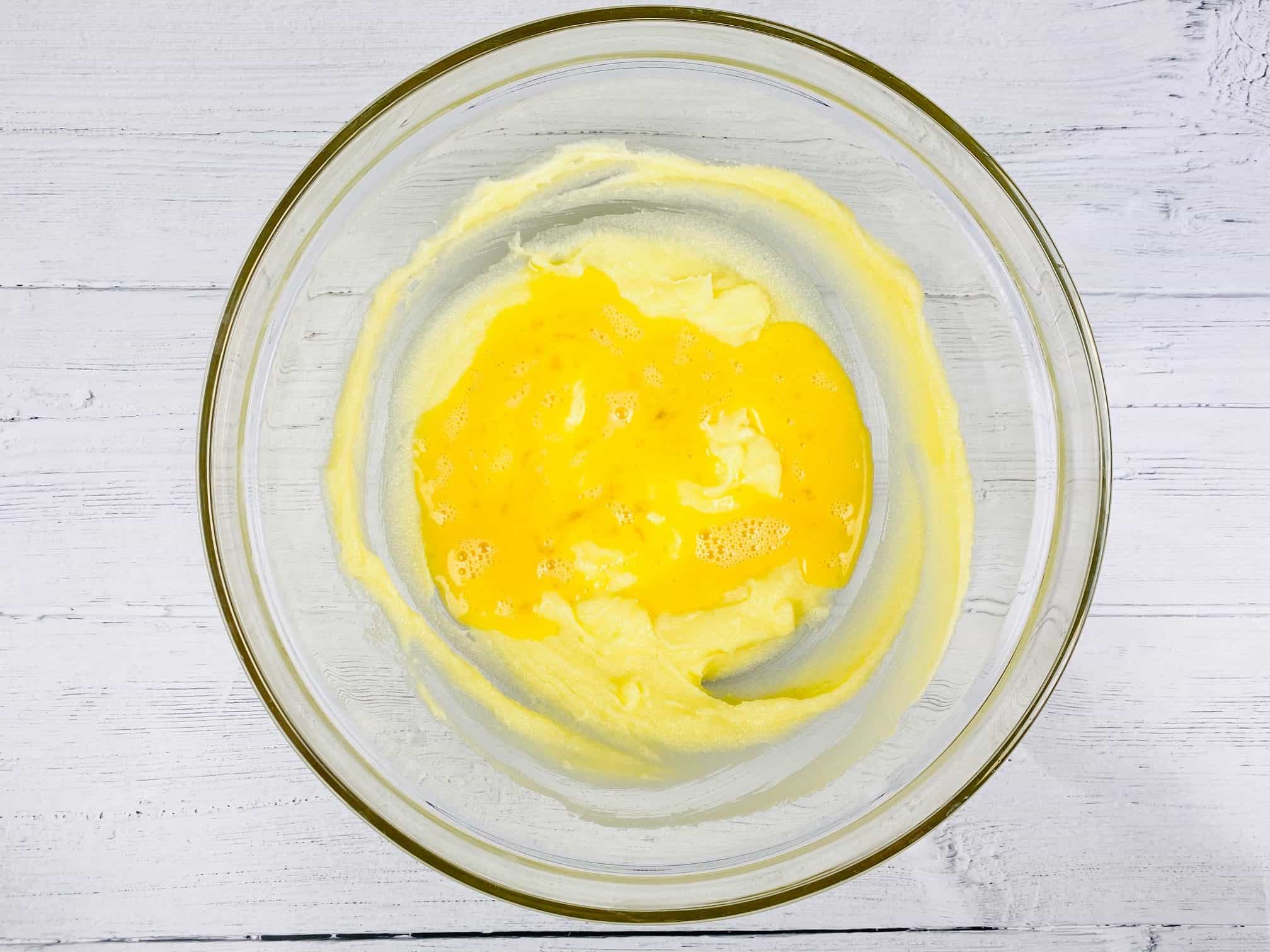 adding beaten egg to creamed butter and sugar