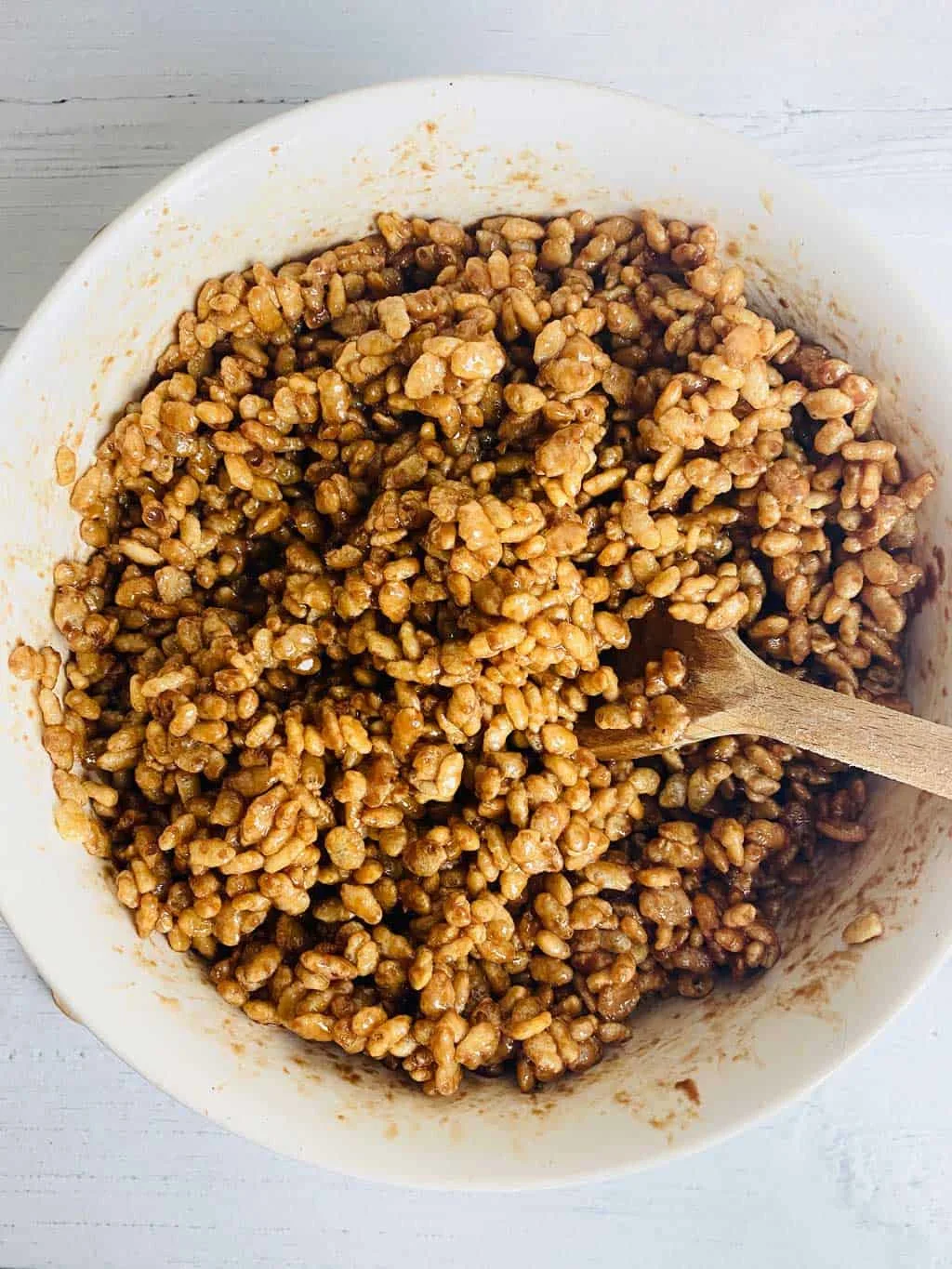 stirring the rice crispies into the melted chocolate 