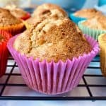 close up of banana muffin in pink case among other muffins