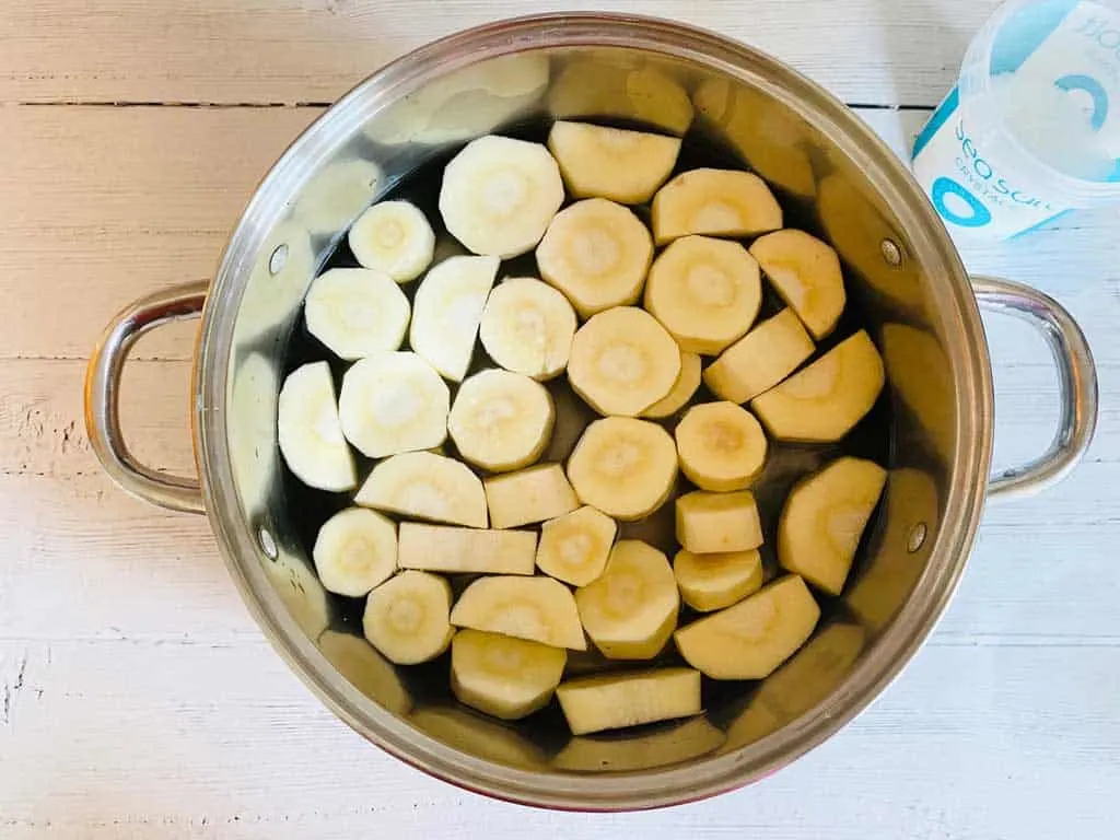 chopped parsnips in a saucepan of salt water