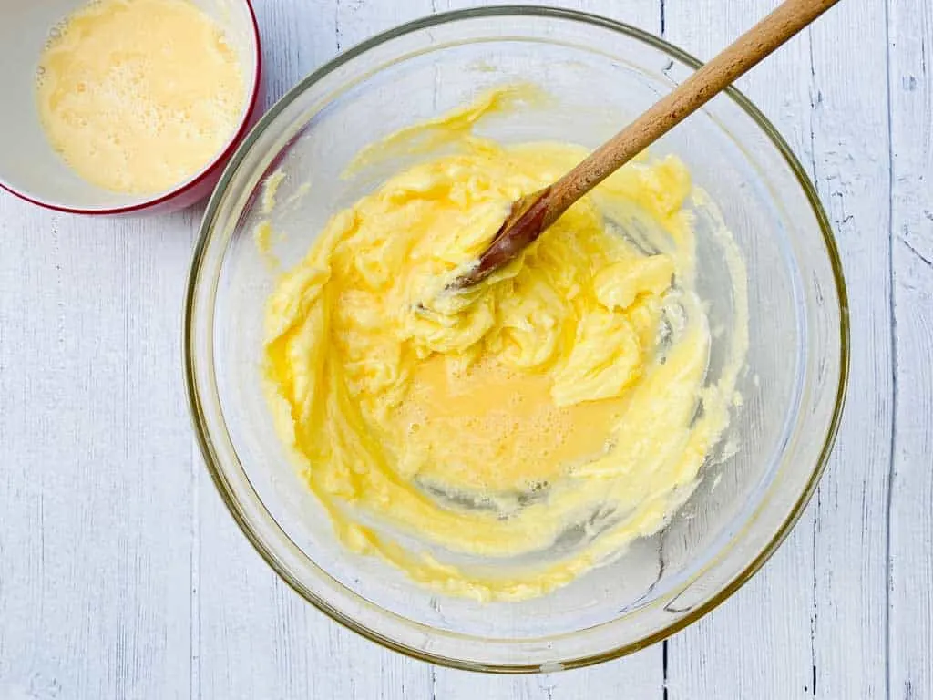 adding egg to creamed butter and sugar