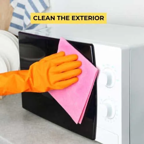 cleaning a microwave with a damp cloth