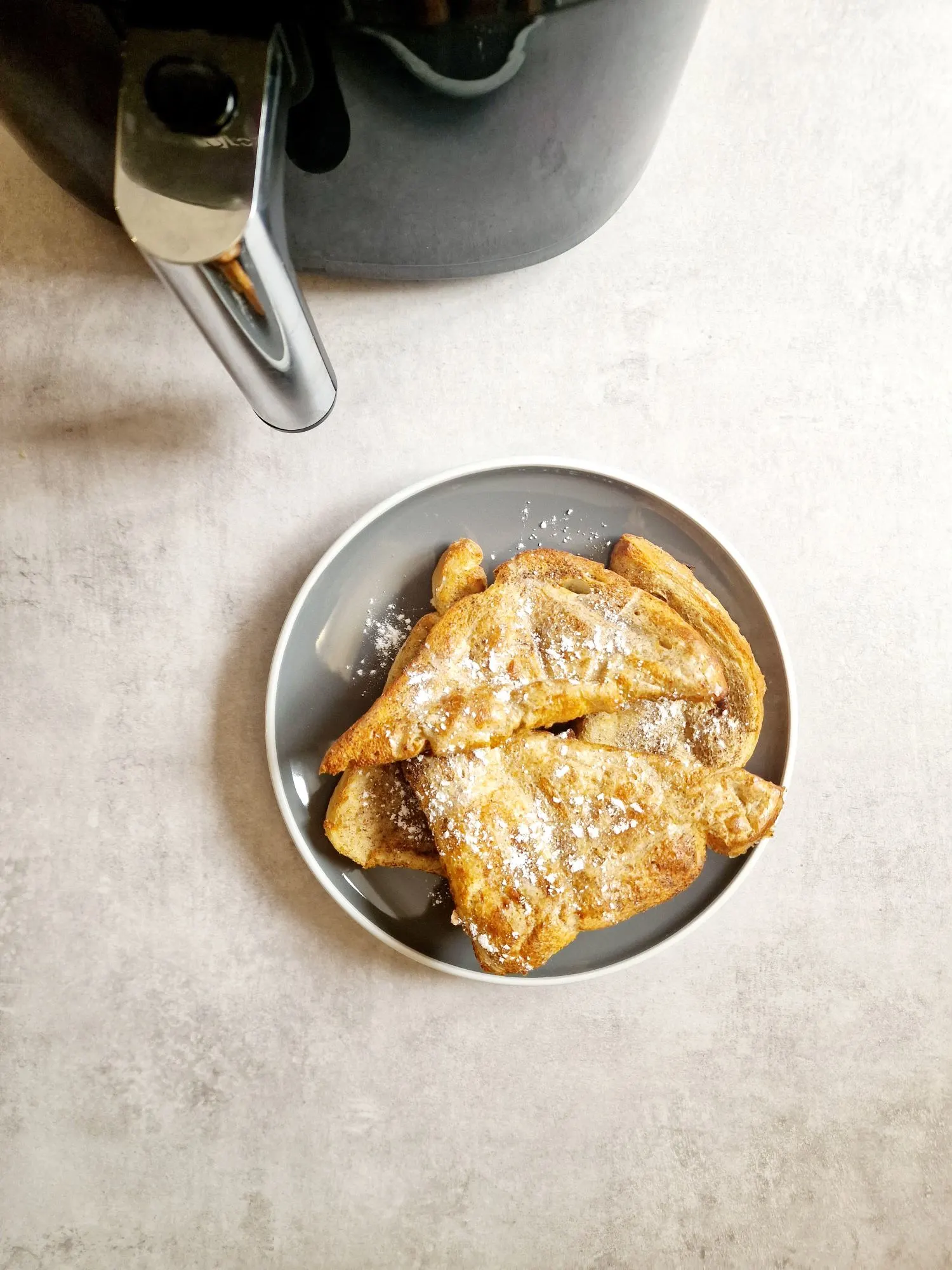 slices of French toast next to air fryer