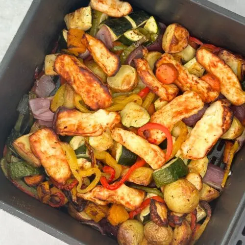 halloumi, courgettes, red onion, new potatoes, red, green and yellow peppers, butternut squash, carrots. All air fried and ready to eat in an overhead shot of the air fryer basket