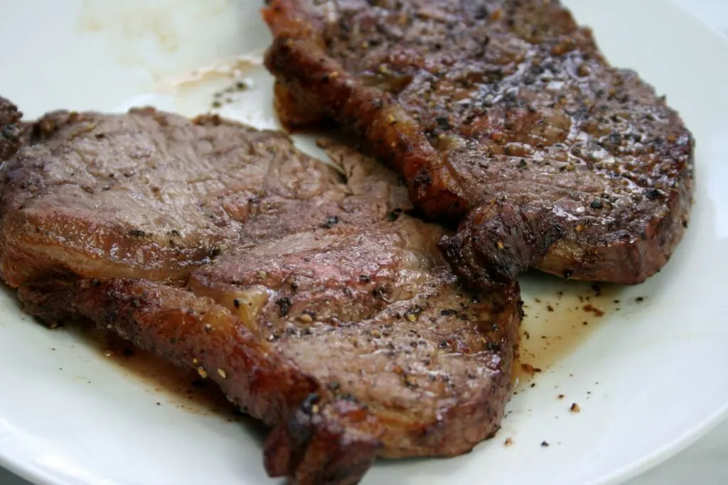 two slices of air fried sirloin steak on a plate