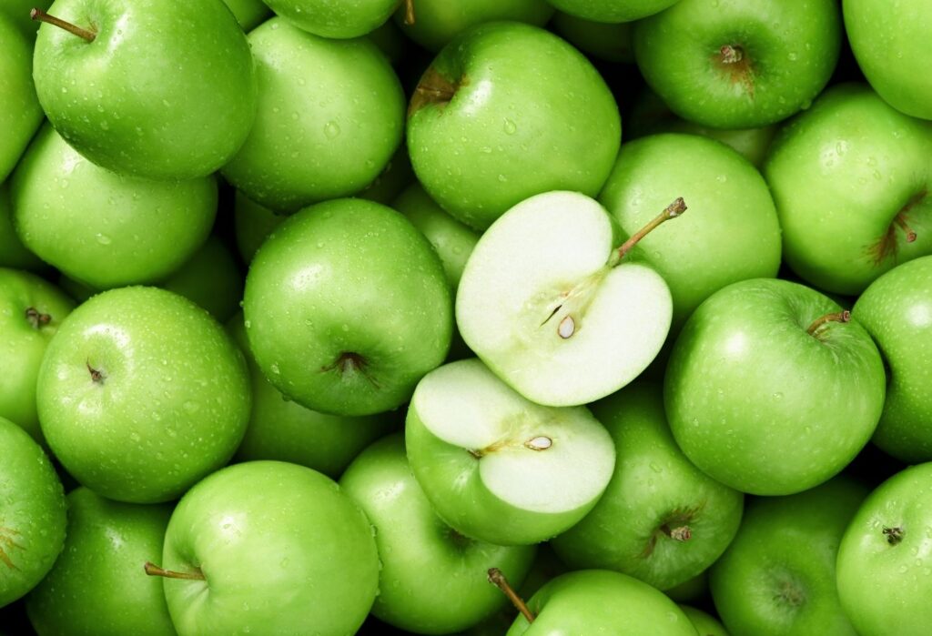 green apples with one sliced in half