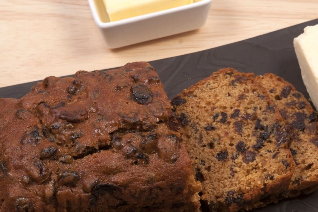 Bara Brith sliced up with butter next to it