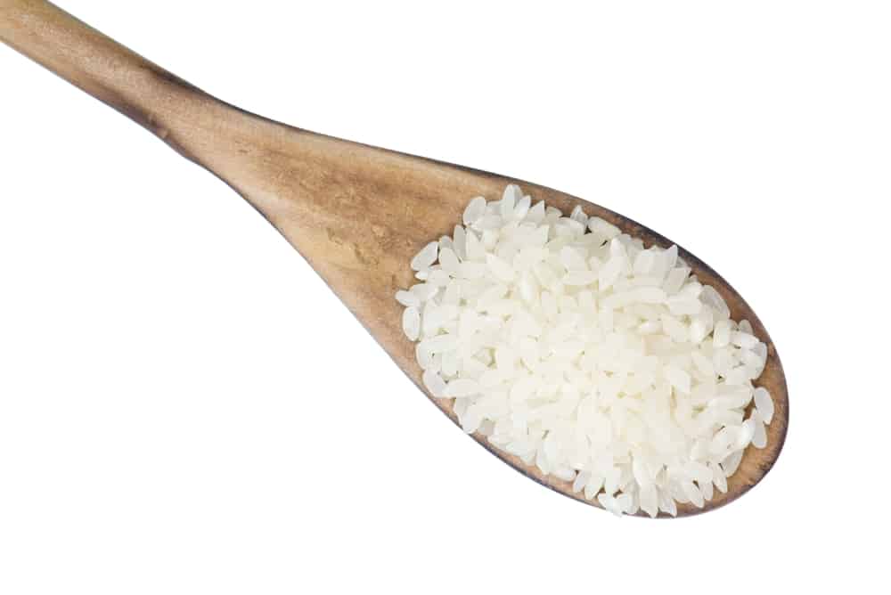 Closeup overview of calrose rice in a wooden spoon