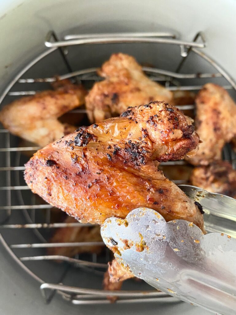 piri piri chicken legs next to air fryer