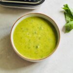courgette and basil soup next to a Ninja soup maker