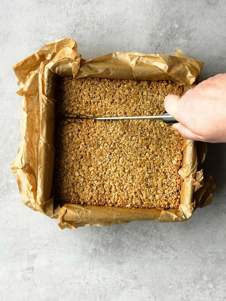 cutting flapjacks while they are still warm in the baking tin