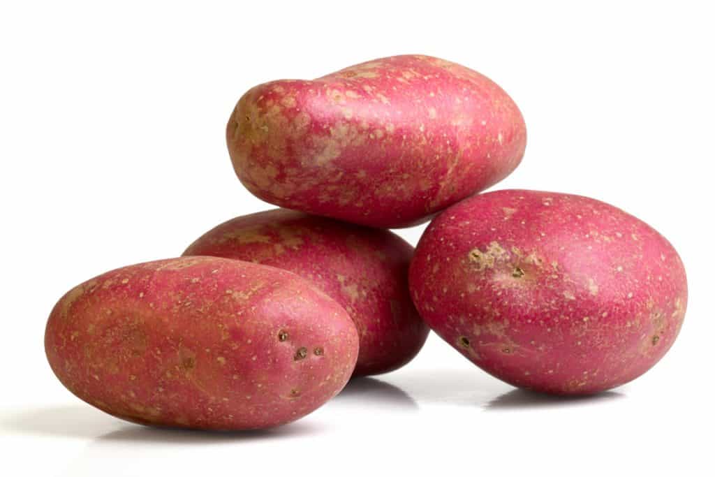 4 Desiree potatoes balanced on top of each other