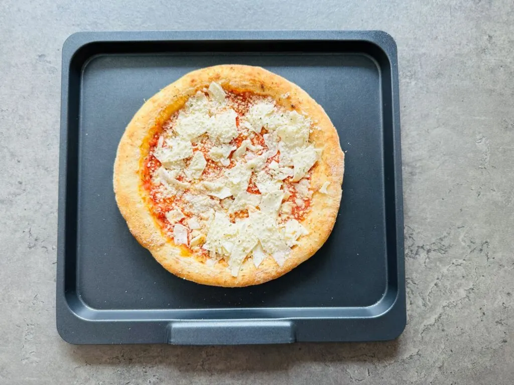 Frozen pizza on air fryer tray