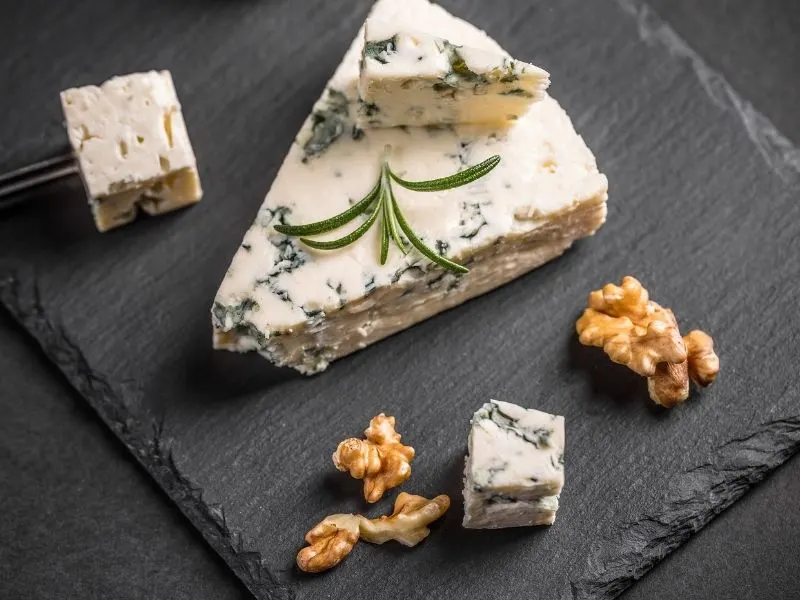 Gorgonzola cheese on board with walnuts