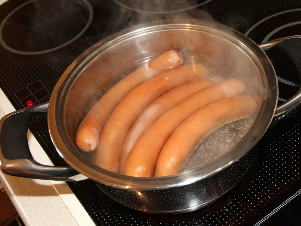 boiling sausages in a saucepan