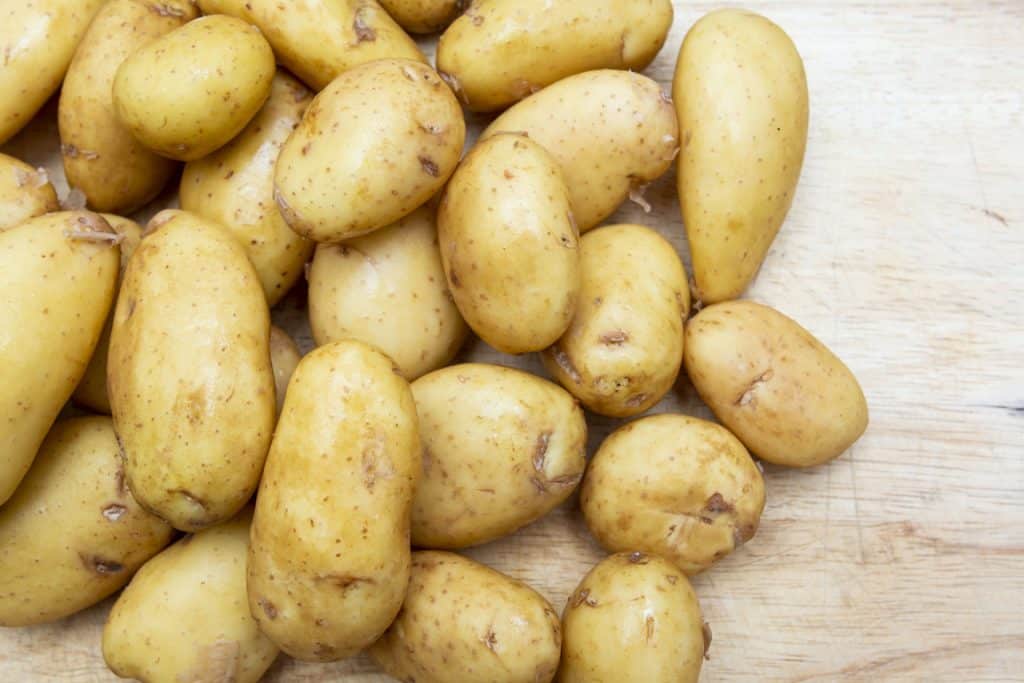 Jersey Royal potatoes laid out on chopping board