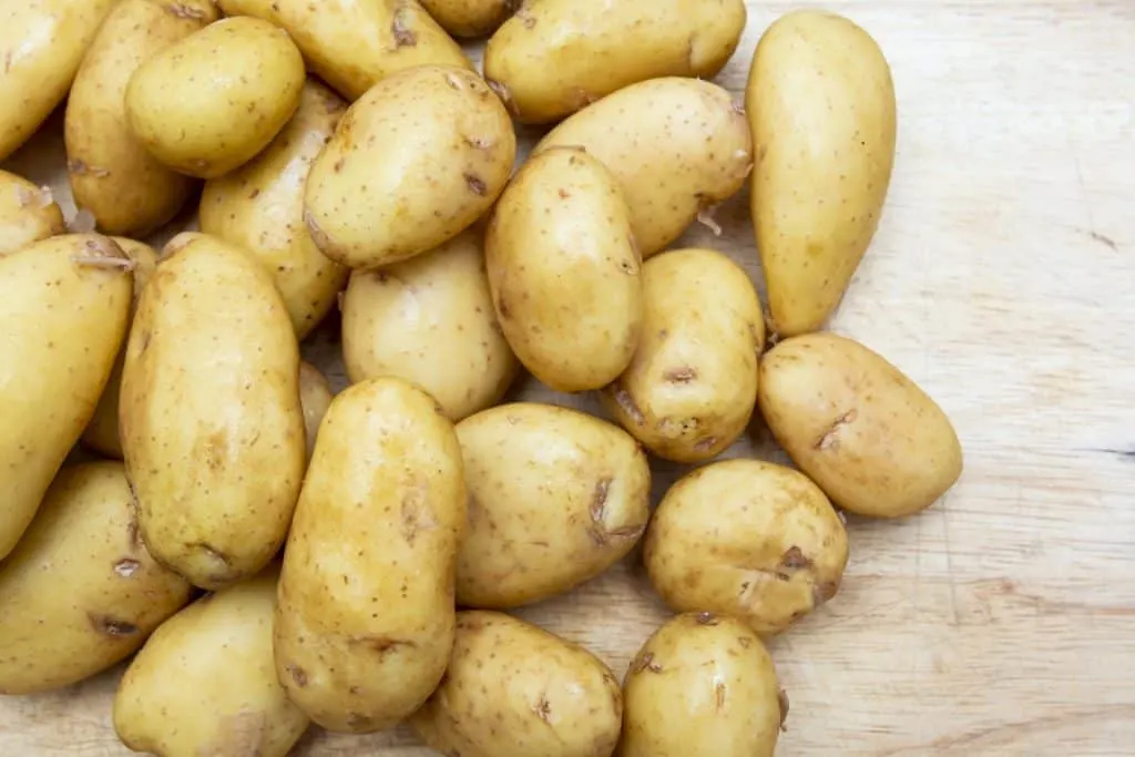 Jersey Royal potatoes laid out on chopping board