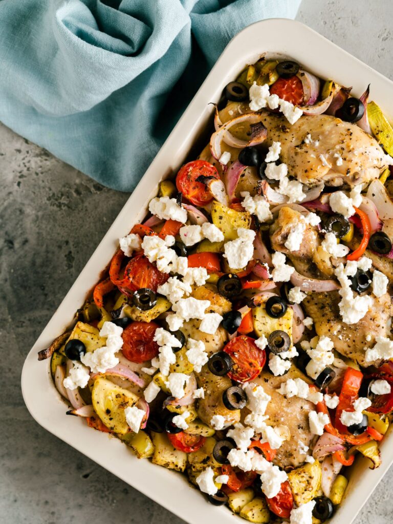 roasted Mediterranean chicken tray bake with olives and crumbled feta cheese sprinkled on top