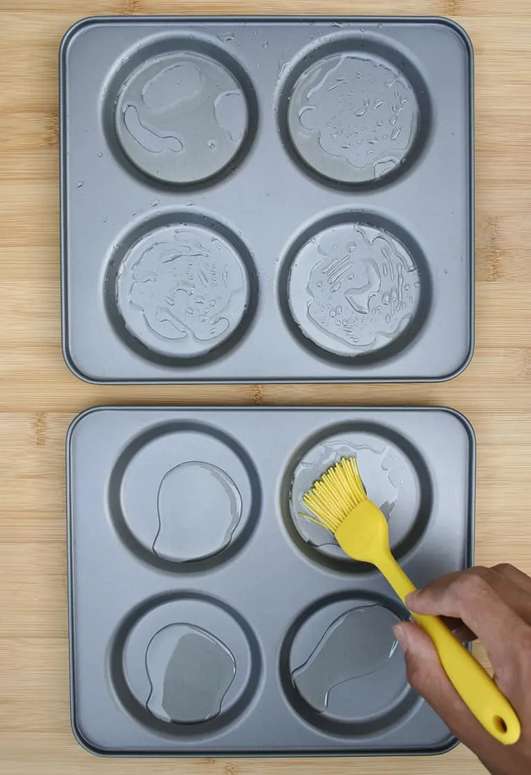 Brushing the Yorkshire pudding trays with oil