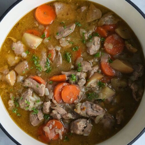 pork apple and cider casserole in a dutch oven casserole dish