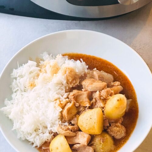 Massaman inspired chicken curry made in a pressure cooker next to a Ninja Foodi
