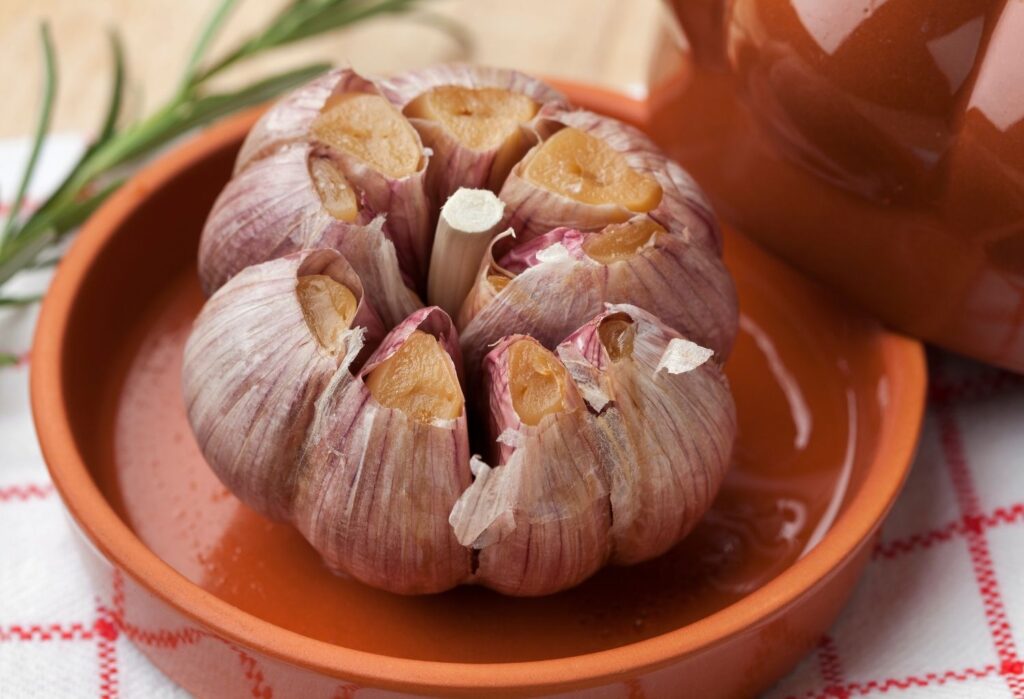 Whole garlic bulb roasted in bowl
