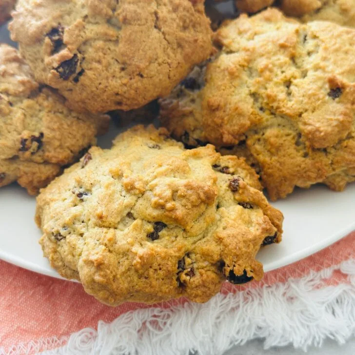 rock cakes on a white plate resting on a pink cloth