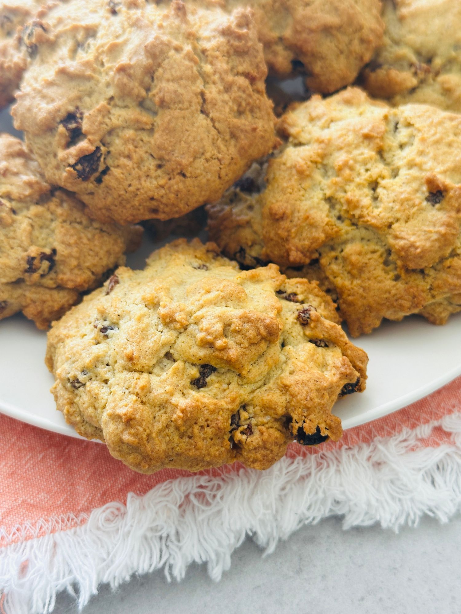rock cakes on a white plate resting on a pink cloth
