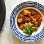 chicken casserole in a bowl next to a slow cooker