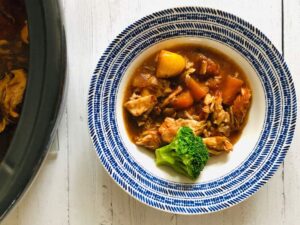 chicken casserole in a bowl next to a slow cooker