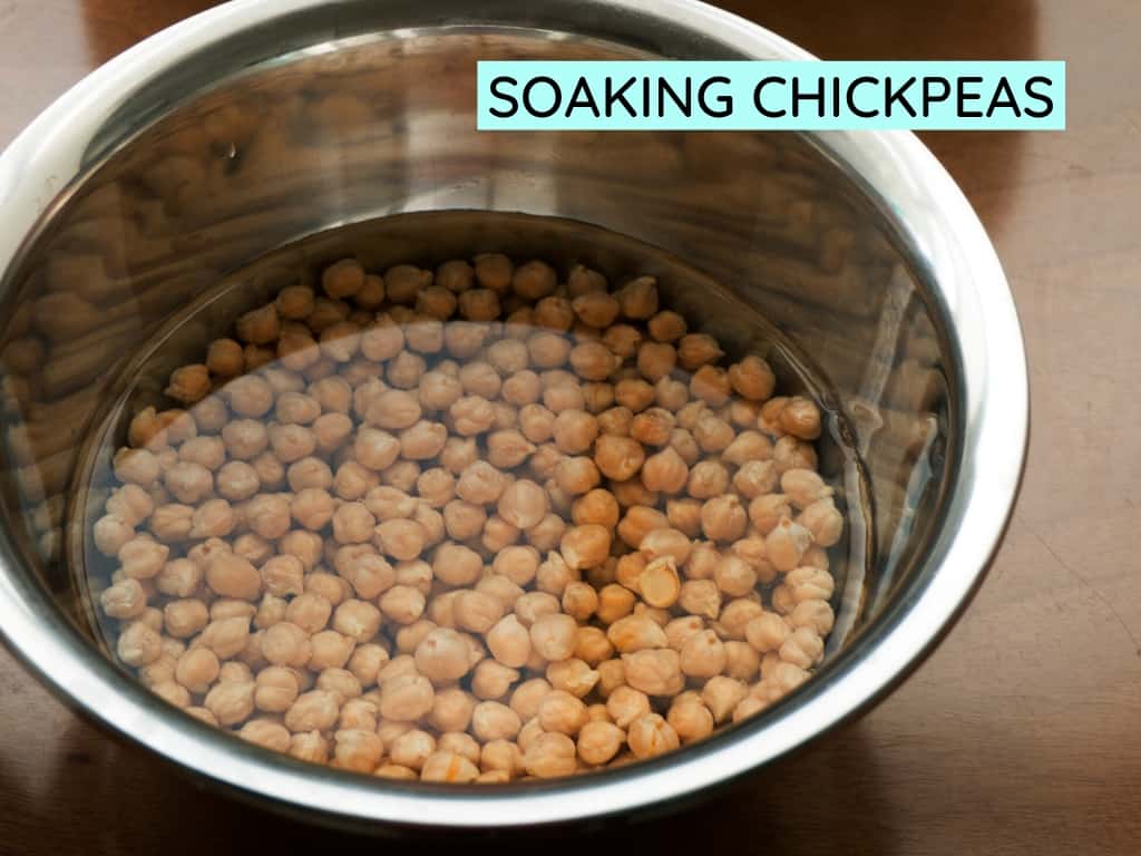 dried chickpeas soaking in a bowl of water