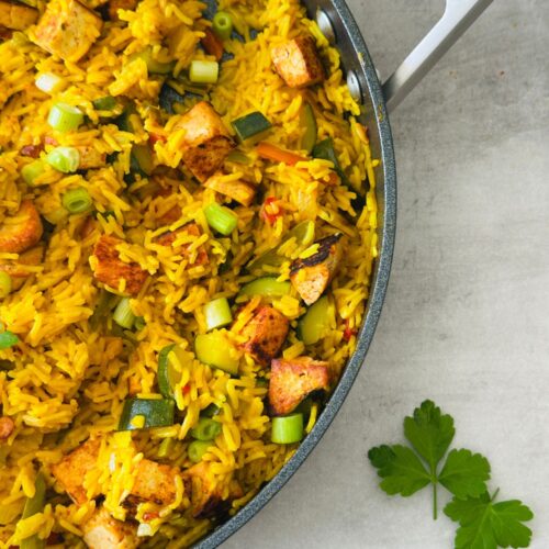 Spicy Vegetable Rice and Crispy Tofu in a large Ninja saute pan with fresh coriander next to it