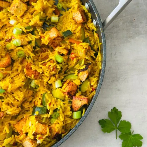 Spicy Vegetable Rice and Crispy Tofu in a large Ninja saute pan with fresh coriander next to it