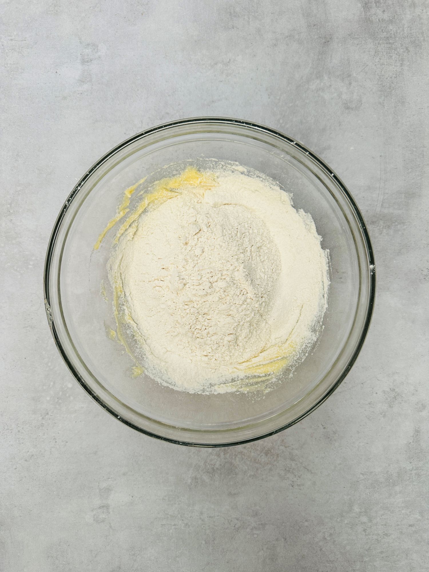 flour added to butter and sugar in a bowl to make shortbread