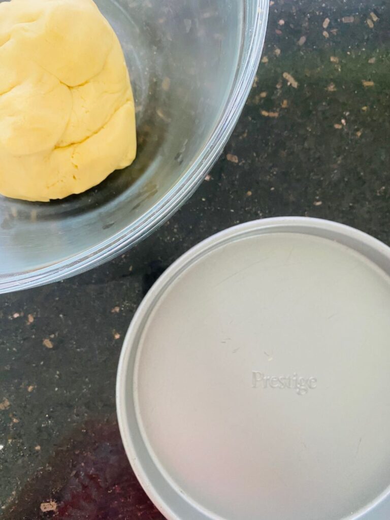 adding dough to baking tin