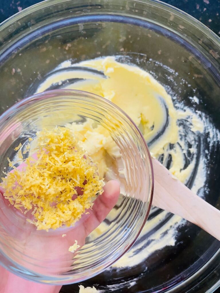 adding lemon zest to butter and sugar