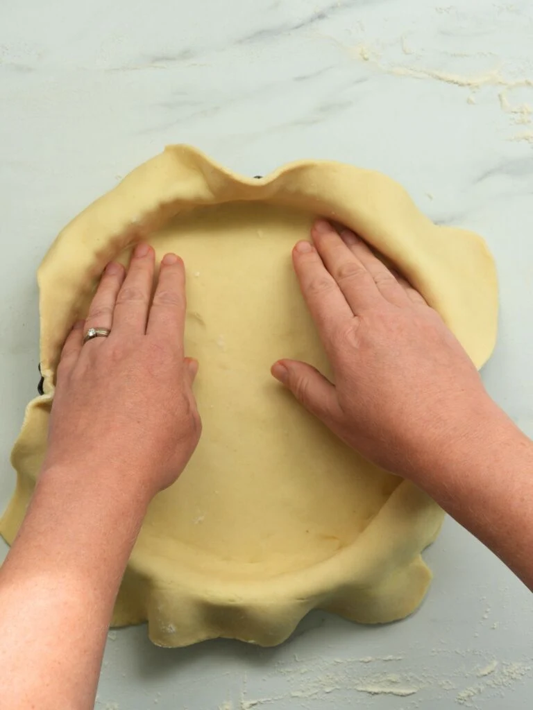 adding pastry to a tart tin